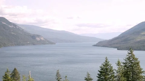 Hazy Mountain Slopes Rising Over Calm Adams Lake on a Smoky Day Video stock 345088052