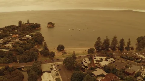 Hazy orange sky drone pan up towards heavens over beach 4K HDR 10bit Stock Footage 122265728