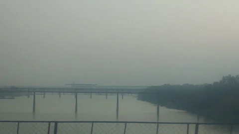 Hazy River Bridge View from Moving Vehicle India Smoggy Morning Overcast Video stock 336410616