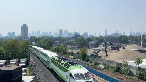 Hazy sky and poor air quality in Toronto with a GO Transit train heading east Stock Footage 314291595
