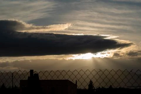 Hazy Sun Rays Breaking Through a Storm Cloud in the Farm Stock Photos