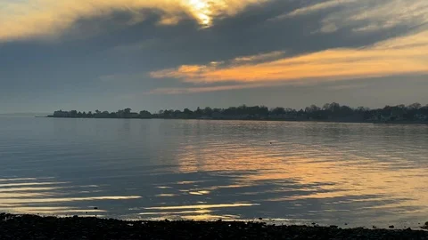 Hazy Sunset at Calm Beach Stock Footage 126997656