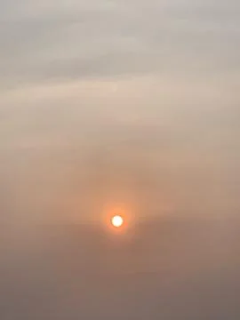 Hazy Sunset Sky with Warm Evening Light over Jakarta Indonesia Stock Photos