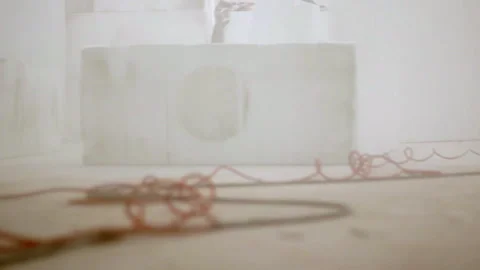 A hazy workspace with white foam blocks and tangled orange cables evokes a Stock Footage 311567219