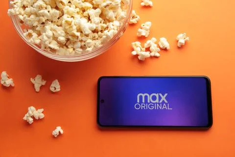 Hbo Max app on the smartphone screen on orange background. App for movies and Stock Photos