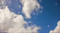 HD 1080p Puffy clouds in crisp blue sunlit sky in timelapse HD Footage