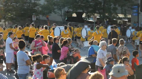 HD 1080p Stock Footage - High School band marching past large downtown crowd Stock Footage