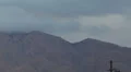 HD 1080p tilt pan - cloud pocket stuck on mountain peak time lapse HD Footage