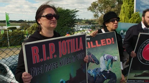HD 1080PTwo protesters holding signs at Jumps demonstration. Stock Footage 87695053