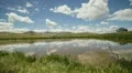 HD 30p v2 Pond at the top of the Continental Divide reflects the sky timelapse HD Footage