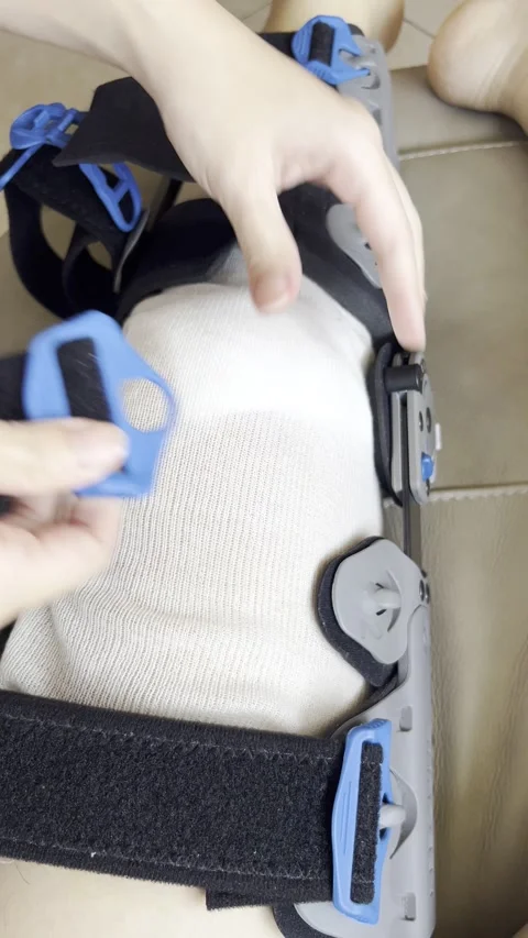 HD | 4K Adjusting Orthopedic Knee Brace On Injured Leg Stock Footage 338240932