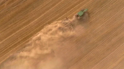HD aerial footage of a modern tractor plowing dry field Stock Footage