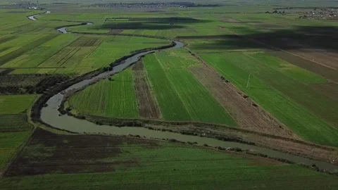 HD Aerial Panorama of a Dramatic River Curve and Vast Farmland Horizon in Stock Footage 330960894