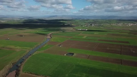 HD Aerial View of Cloud Shadows over Agricultural Patchwork and Winding Stream Stockbeeldmateriaal 330960729