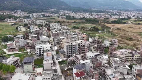 HD Aerial View of a Small City Nestled in Dense Mountain Valley Stock Footage 328487536