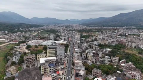 HD Aerial View of a Small County Town Surrounded by Majestic Mountain Ranges Stock Footage 328487602