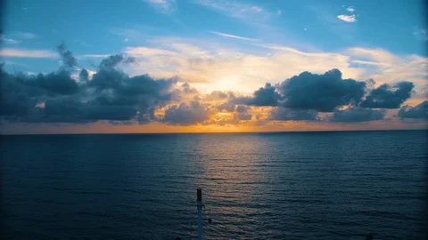 HD - Amazing Sunset over Ocean Peaking Through Clouds Stock Footage 128935868
