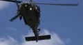 HD blackahwk appears from behind trees w sound close up HD Footage