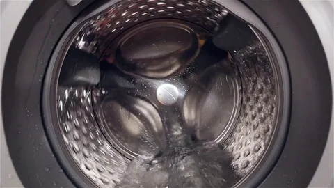 HD - Camera moves to inside the washing machine. Slow-mo Stock-Footage 83485525