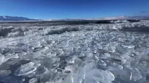 HD Close-up of Shimmering Ice Chunks on Frozen Lake Shore Stock Footage 328444599