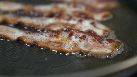 HD | Cooking Bacon with Rack Focus Stock Footage 76708559