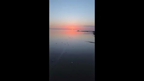 HD Drone Footage at sunset over a body of water and boats Stock Footage 336211497