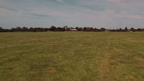 HD Drone shot going across a field towards a building Stock Footage 163185915