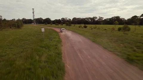HD Drone shot of tracking a car going fast down a dirt road Stock Footage 163185880