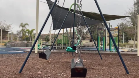 HD Empty Swing in a Children's playground in on a Cloudy day Video stock 230194008