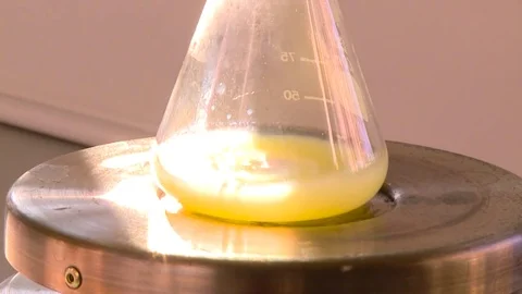HD Erlenmeyer flask with a yellow solution Stock Footage 82618381