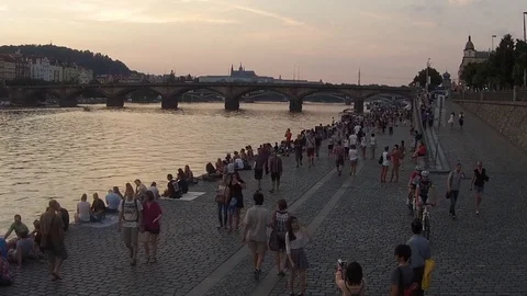 HD EXT DUSK aerial walking people along the river in old downtown Stock Footage 73425220