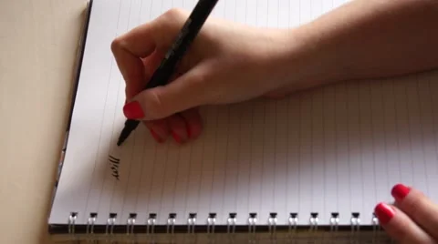HD Female hand writes ""will you marry me"" on lined paper Stock Footage 56726900