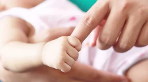 HD Footage of baby holding mother finger, close up Stock Footage