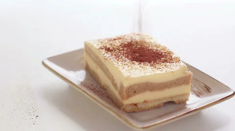 HD footage, dusting tiramisu cake with powdered cocoa Stock Footage