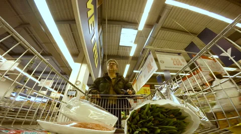 HD Footage Man in WInter Jacket Walking in Supermarket Stock Footage 54970990