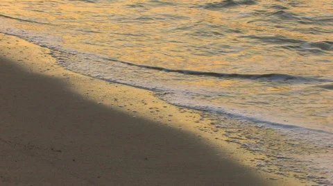 HD Gentle waves on a sandy beach in sunrise, closeup Stock Footage 597964