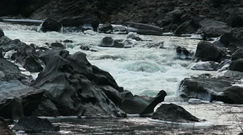 HD Iced Black Rocks in a Mountain River Stock Footage 45847043