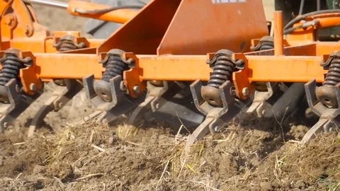 HD The implement of a tractor plowing the land of cultivation Stock Footage 92845426