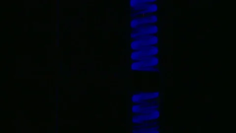 HD Luminescent liquid falling through a coil to a flask Stock Footage 82618339