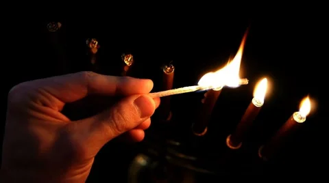 HD - Man lights a candle in a candlestick Stock Footage