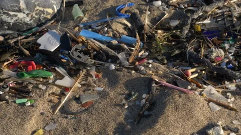 HD microplastics washed up along a strandline on a Welsh beach Stock Footage 186469823