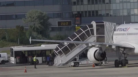 HD Passengers disembark plane using boarding stairs then board airport bus Stock Footage 120135716