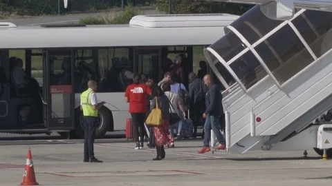 HD Passengers disembark plane using boarding stairs then board airport bus V3 Stock Footage 120135894