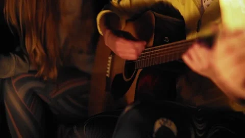 HD. Playing guitar by the campfire. Stock-Footage 204718620