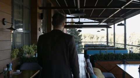 HD Shot from back man is walking in cafe's terrace Stock-Footage 95911085