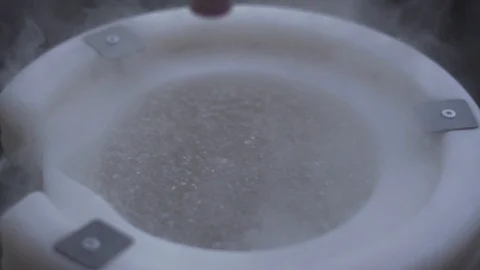 HD Slow Motion Footage of liquid Nitrogen Bubbling in Open Top Container Stock Footage