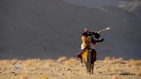 HD, Slow motion. Hunter with an eagle in the steppe of Mongolia Stock Footage 99363141
