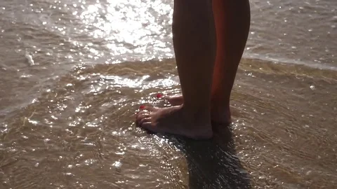 HD Slow Motion. sea waves crashing against a woman's legs Stock Footage 80093867