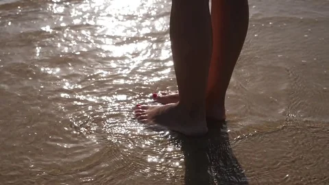 HD Slow Motion. sea waves crashing against a woman's legs Stock Footage 80093874