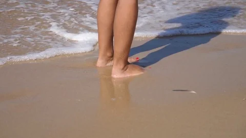HD Slow Motion. sea waves crashing against a woman's legs Stock Footage 80093885